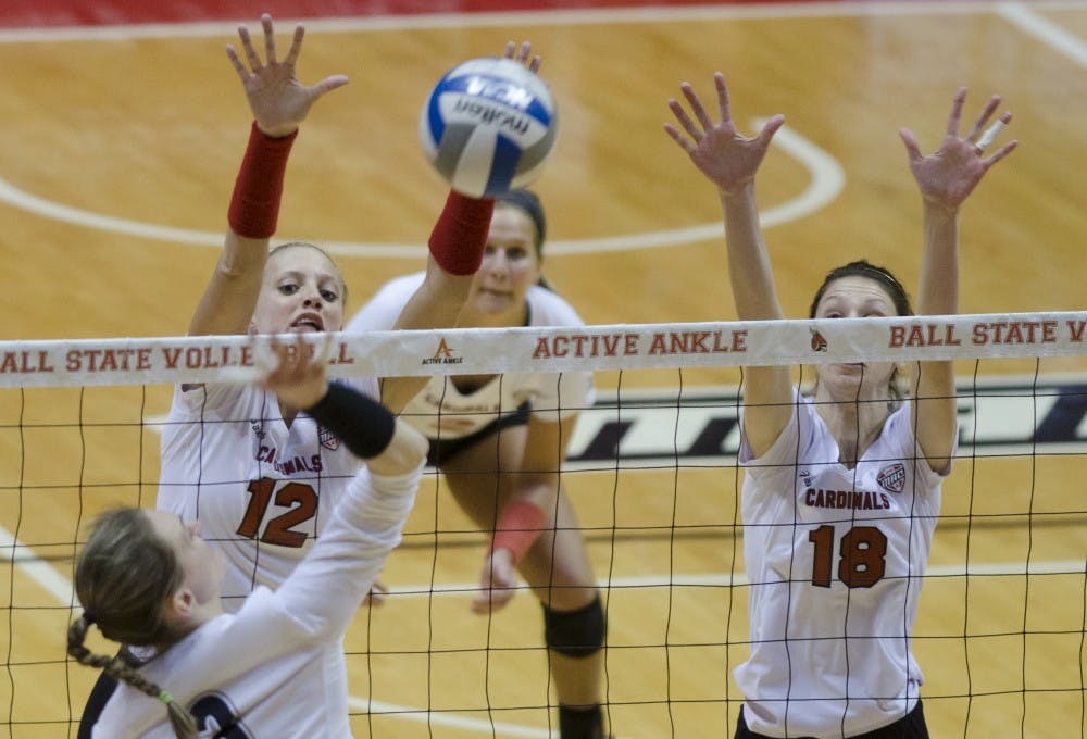 Junior setter Jenna Spadafora and redshirt junior middle blocker Hayley Benson attempt to block the ball during a set against Akron on Nov. 15 at Worthen Arena. DN PHOTO BREANNA DAUGHERTY