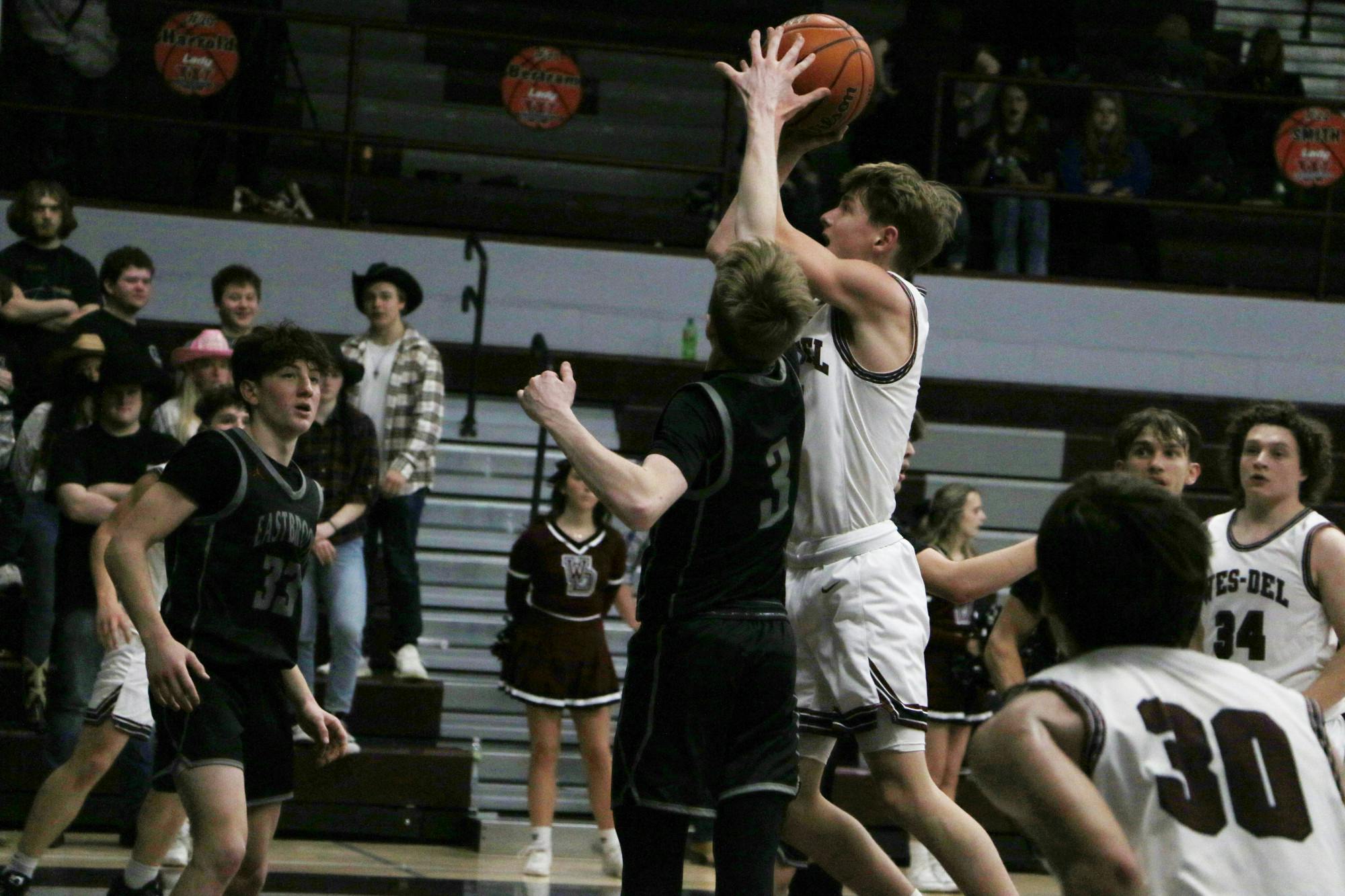 Wes-Del senior Cade Pretorius attempts a contested shot against an Eastbrook defender Feb. 10 at Wes-Del Middle/Senior High School. Zach Carter, DN