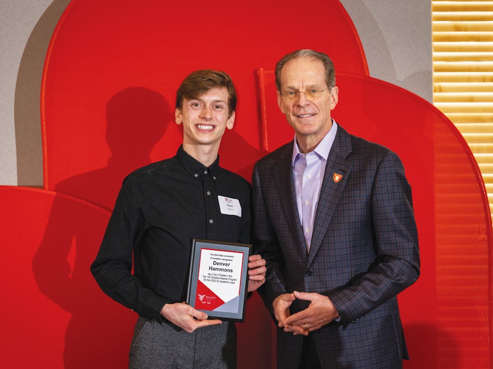 Top 100 student Denver Hammons (left) poses with Ball State University President Geoffrey Mearns (right) at the Top 50 brunch March 25 at the Alumni Center in Muncie, Ind. Samantha Blankenship, Photo Provided