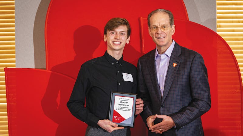 Top 100 student Denver Hammons (left) poses with Ball State University President Geoffrey Mearns (right) at the Top 50 brunch March 25 at the Alumni Center in Muncie, Ind. Samantha Blankenship, Photo Provided