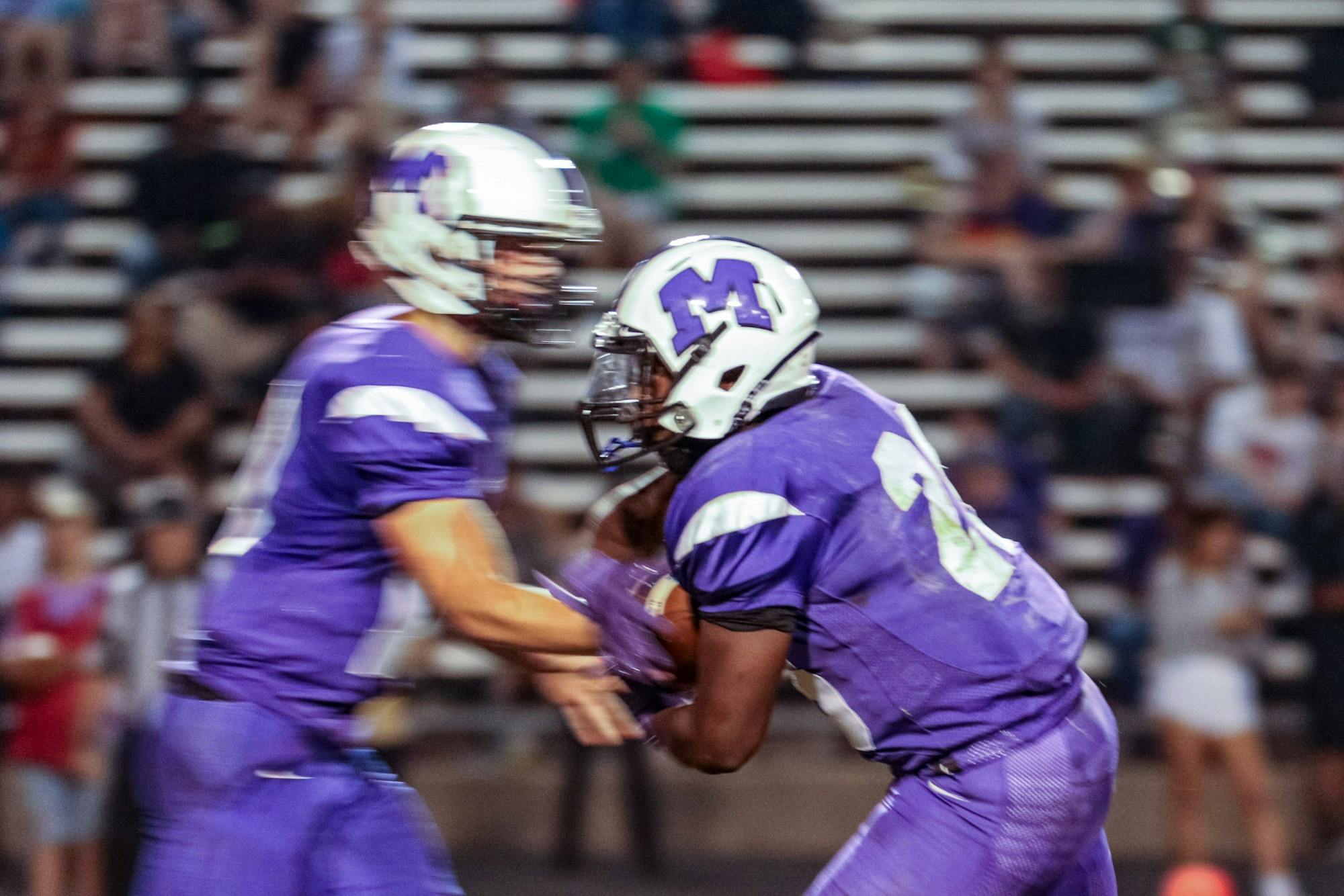 Junior quarterback Max Pittman (17) hands the ball off in the second half of the Muncie Central homecoming football game Sept. 20, 2019. Muncie Community Schools outlined its phased plan to bring back its athletics during the fall 2020 semester. Paul Kihn, DN