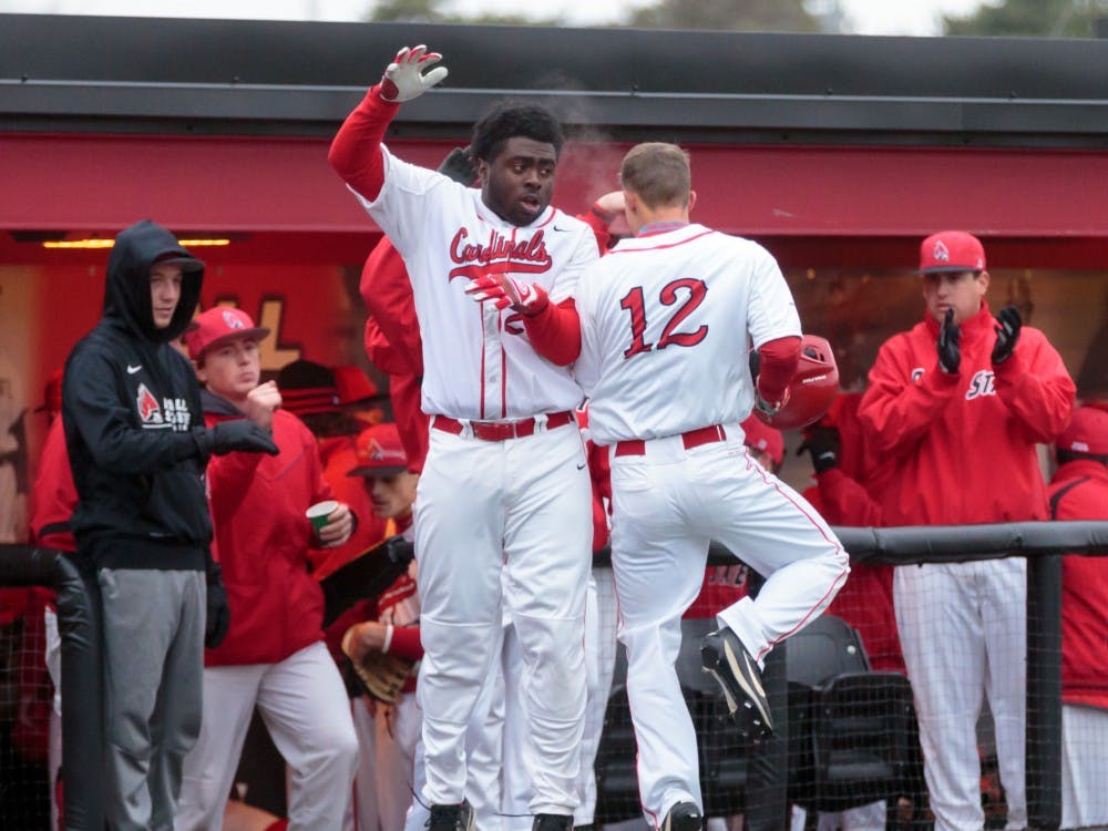 Freshman outfielder Joe Gunn celebrates with his teammates after a score during the game against Dayton at the Ball Baseball Diamond on March 18. The Cardinals hosted a double header for this season's home opener and won both games. The Cardinals won 6-0 in the first game and 4-3 in the second game. &nbsp;Kyle Crawford, DN
