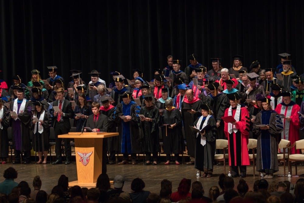 Isaan Mitchell, President of Student Government Association, leads Emens Auditorium in the Beneficence Pledge during the freshmen convocation Sunday, Aug. 19. Eric Pritchett, DN