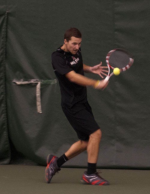 Senior Dalton Albertin returns a volley during his singles match against Detroit Mercy on Jan. 25. The men’s tennis team is headed into the postseason ranked first in the MAC. DN FILE PHOTO BOBBY ELLIS