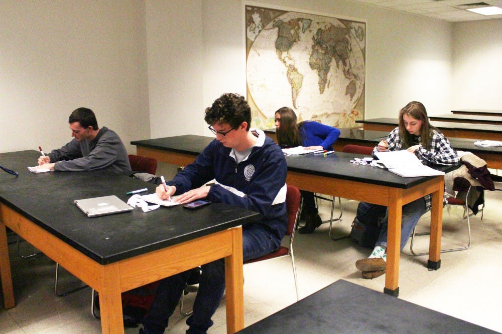 Members of Natural Resources and Environmental Management club decorate reusable bags Feb. 13, 2019, in the West Quad Building. The club meets once a week and participates in community service. Demi Lawrence, DN