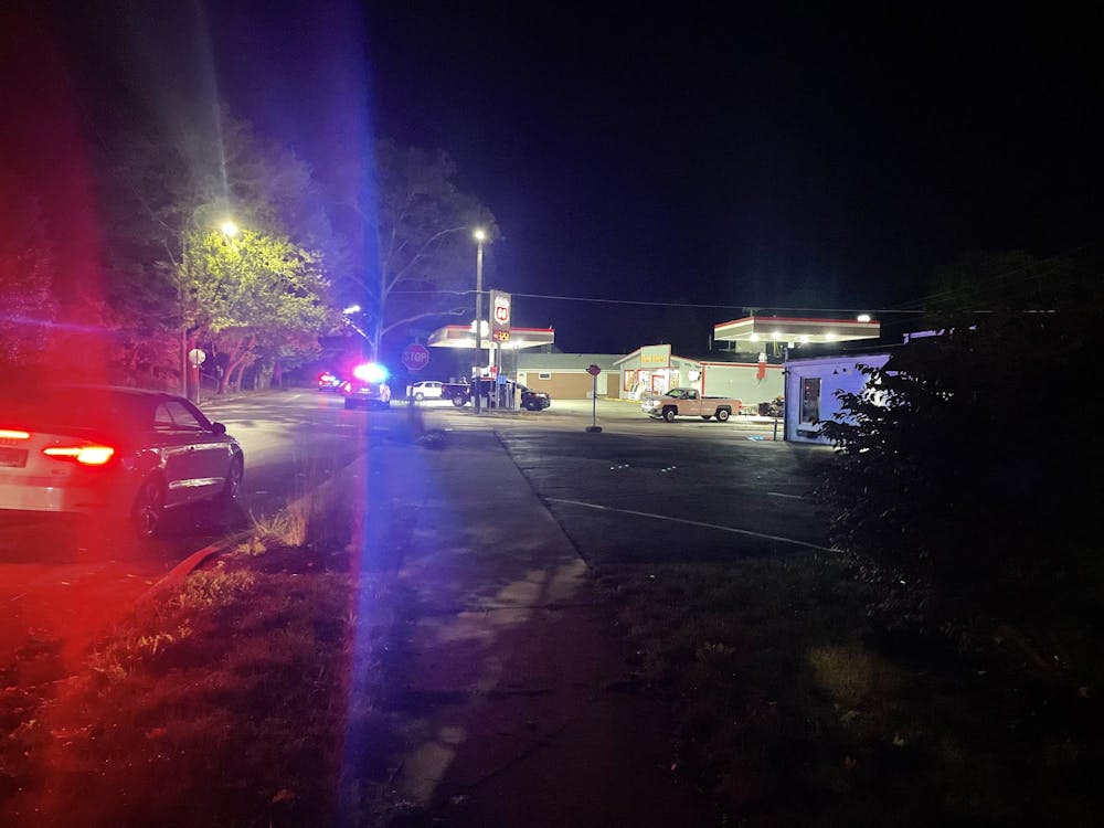 A police car flashes its lights at the gas station in the area of Reserve and University the night of Oct. 1. Ball State University Police and Muncie Police Department investigated shots fired. Zach Carter, DN