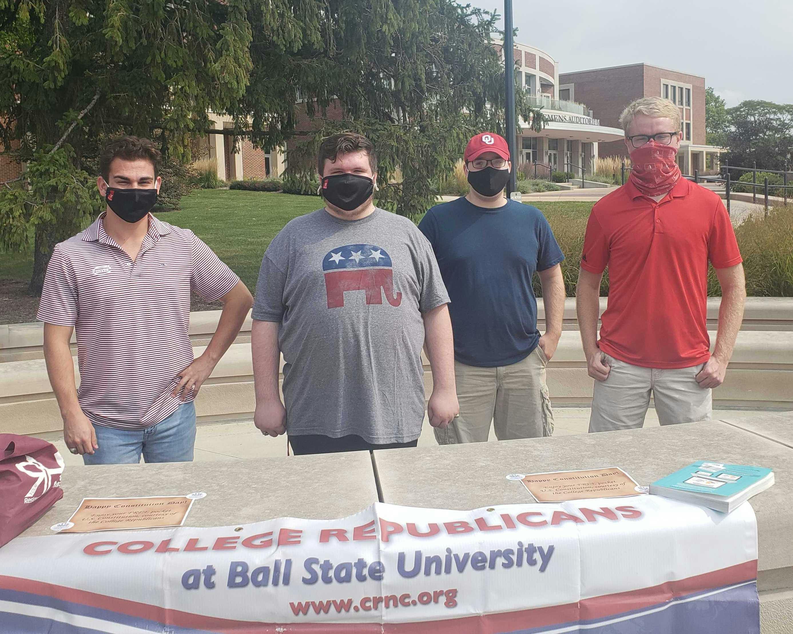 Dylan Lewandowski, Chase Braden, Jacob Knapp and Gaven Schulz distribute pocket U.S. Constitutions at the Scramble Light Sept. 17, 2020. The Ball State College Republicans and the College Democrats have each been involved in outreach projects to register students to vote. Jaden Hasse, DN