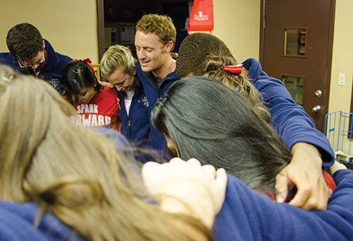 President-elect Malachi Randolph leads his slate and supporters in prayer at the Multicurtural Center on Feb. 26. A Spark Forward won the Student Government Association election with 2,189 votes. DN PHOTO MARCEY BURTON