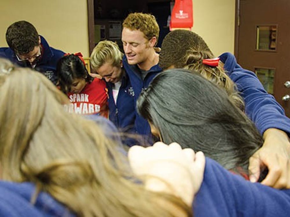 President-elect Malachi Randolph leads his slate and supporters in prayer at the Multicurtural Center on Feb. 26. A Spark Forward won the Student Government Association election with 2,189 votes. DN PHOTO MARCEY BURTON