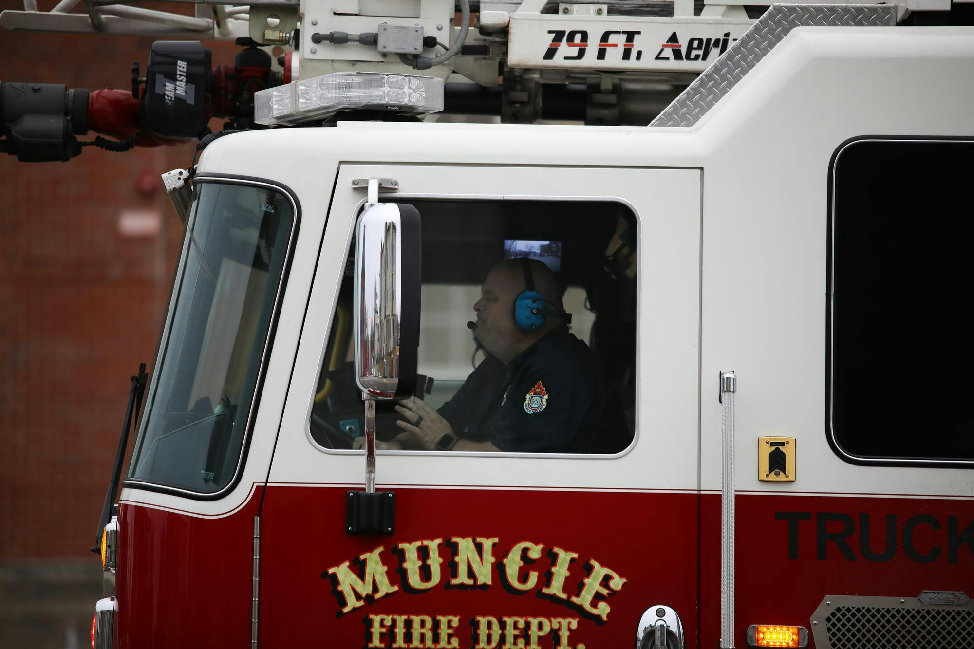 A Muncie Fire Department firefighter drives through Muncie in February 2024. During the holiday season, the Muncie Fire Department ramps up its annual Toys for Tots program, collecting and distributing toys to families in need across the community.&nbsp;Isabella Kemper, DN