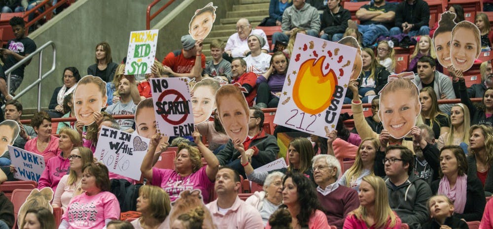Fans holding up signs at Ball State gymnastics quad-meet on Feb. 14 at Worthen Arena.&nbsp;