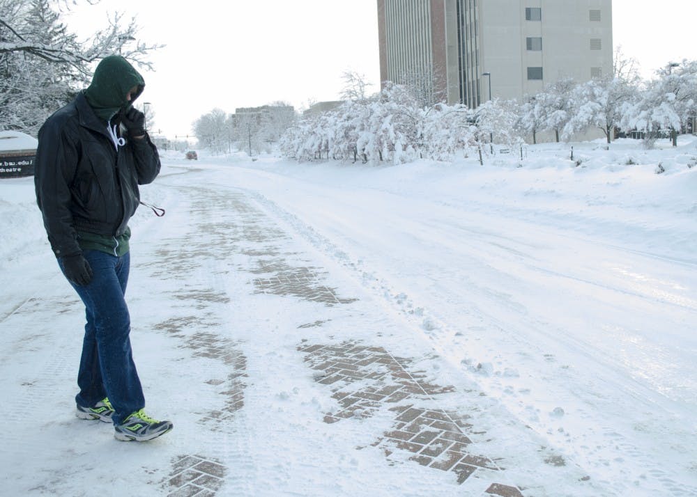 Freshman music education major Justin Swisher gets ready to cross McKinley Avenue on Jan. 6. DN PHOTO BREANNA DAUGHERTY 