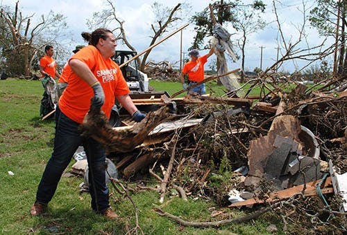 Stephanie Houk, of Waukesha, carries tree limbs while cleaning up, May 26, 2013 in Moore, Okl. Houk was one of many volunteers who was helping clean up after storms that effected communes in Oklahoma. MCT PHOTO 