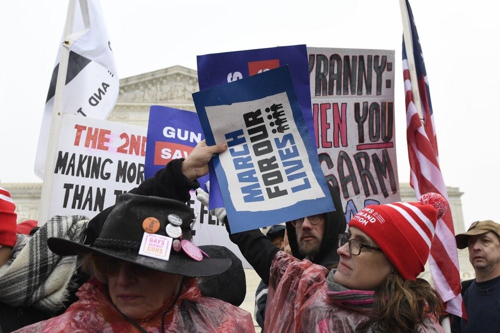<p>Protesters gather outside the Supreme Court in Washington, Monday, Dec. 2, 2019, during arguments in the first gun rights case before the Supreme Court in nine years. The case was filed by three New York City gun owners who are challenging a ban on carrying a licensed handgun outside city limits to a gun range, shooting competition or second home outside city limits. <strong>(AP Photo/Susan Walsh)</strong></p>