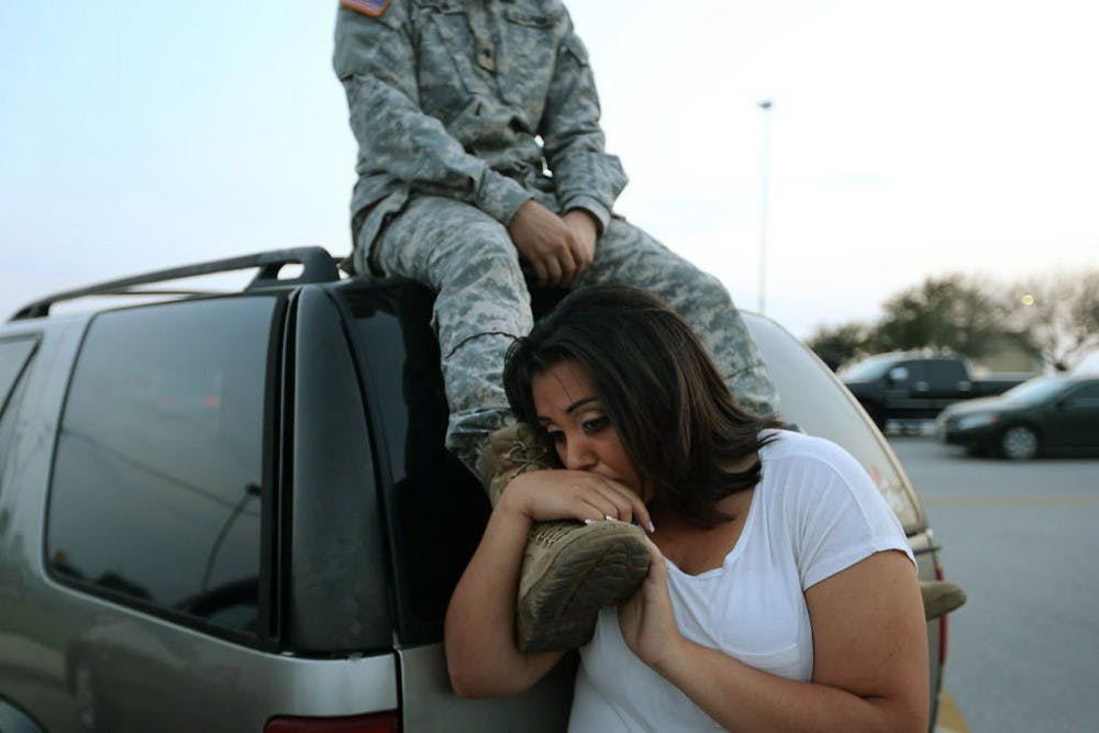 Lucy Hamlin and her husband, Spc. Timothy Hamlin, wait to get back to their home on the base following a shooting incident at Fort Hood, Texas, on Wednesday, April 2, 2014. (Deborah Cannon/Austin American-Statesman/MCT)