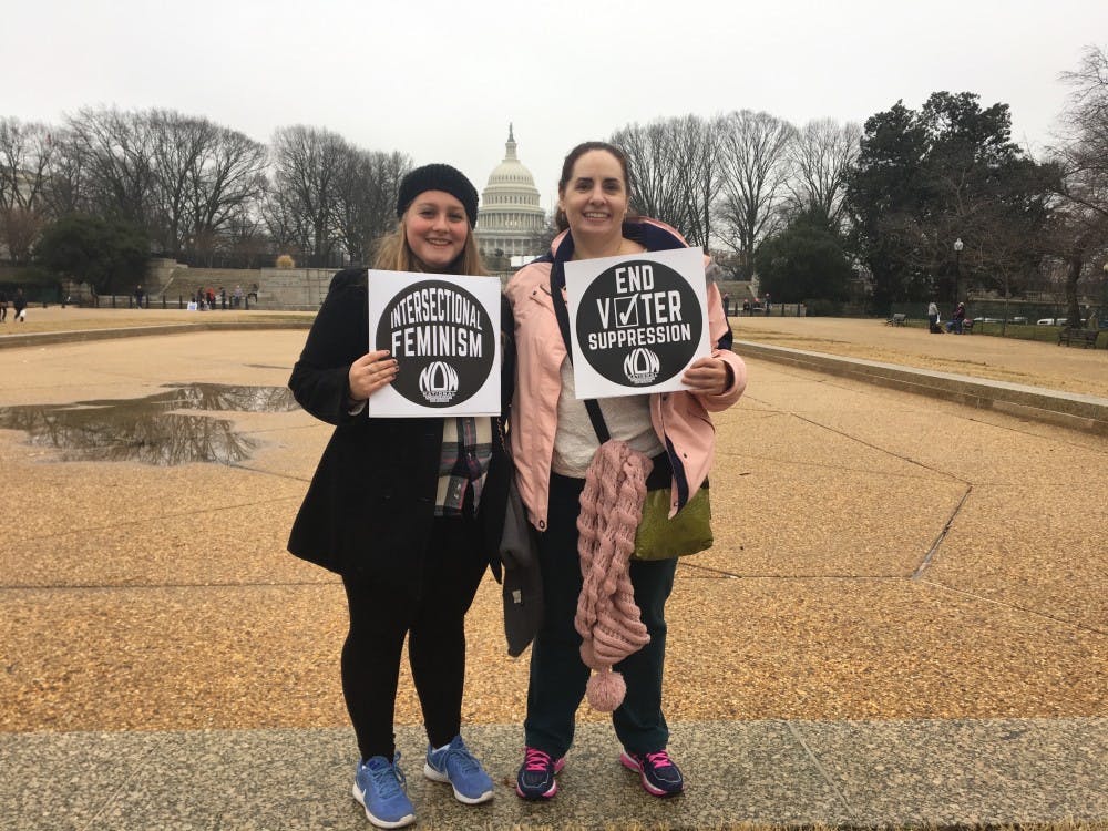 Amanda Belcher and her aunt, Christina Warden hold up signs on Jan. 21 at the Women's March on Washington. They traveled from Chicago and Muncie, respectively, in order to attend the march. Amanda Belcher // DN