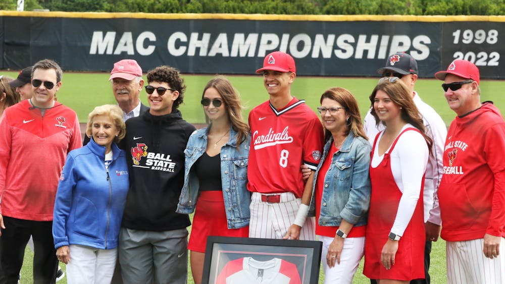 Ball State senior Adam Tellier poses with Ball State head coach Rich Maloney, Ball State athletic director Jeff Mitchell and family during pregame May 20 at First Merchants Ball Park Complex. Zach Carter, DN