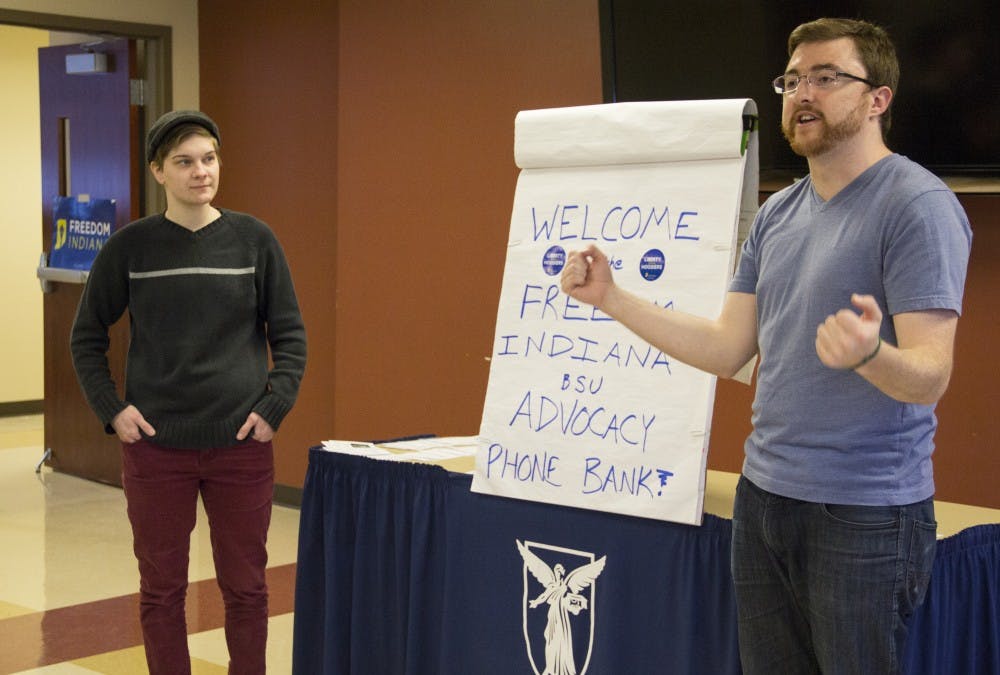 Matt Marko, lead campus organizer for Freedom Indiana, and SGA representative of Spectrum Carli Hendershot, a sophomore political science major, explain the process for calling residents. Students called households for over two hours to persuade them to leave a message to their representatives about their concern for HJR-3. DN PHOTO EMMA ROGERS