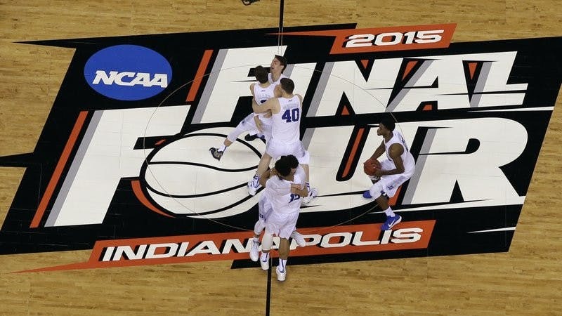 FILE - Duke players celebrate after the NCAA Final Four college basketball tournament game against Wisconsin in Indianapolis, in this Monday, April 6, 2015, file photo. The NCAA announced Monday, Nov. 16, 2020, it plans to hold the entire 2021 men&#x27;s college basketball tournament in one geographic location to mitigate the risks of COVID-19 and is in talks with Indianapolis to be the host city (AP Photo/David J. Phillip, File) 