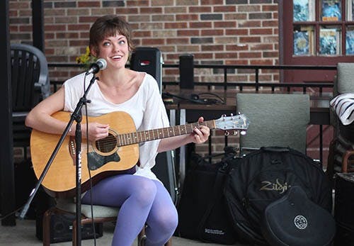 Marta Vitolins sings and plays guitar at the Cup during the free art show hosted by Glue & Scissors Marta is the Comunications Chief of Glue & Scissors, the Muncie-based group that strives to make people more aware of art. DN KRYSTAL BYERS 