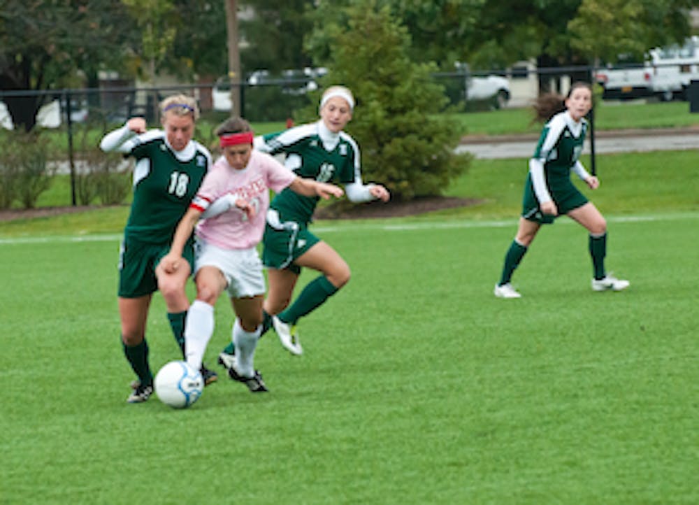 DN FILE PHOTO JONATHAN MIKSANEK Midfielder Sarah Orisich attempts to push between two Eastern Michigan players. Orisich played the last game of her career this weekend with a loss against Kent State. 