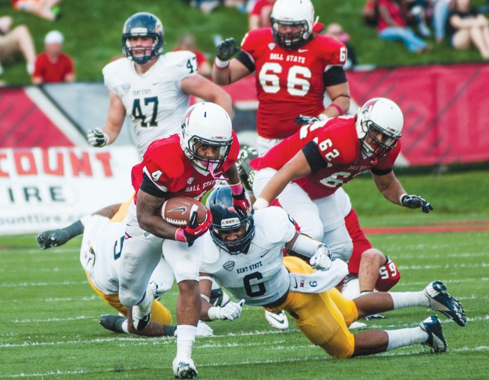 Running back Horactio Banks breaks away from the Kent State defensive line on Oct. 12. Banks has been declared out for the remainder of the season due to a knee injury, forcing the offense to adapt. DN PHOTO JONATHAN MIKSANEK