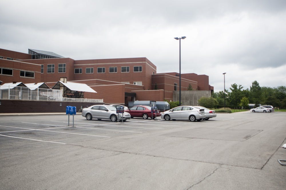 The parking lot between the Arts and Journalism and Applied Technologies buildings sits mostly empty while construction crews occupy half of it with equipment and offices. To make up for the space taken by construction, handicap spaces have moved to the main part of the parking lot. DN PHOTO JORDAN HUFFER