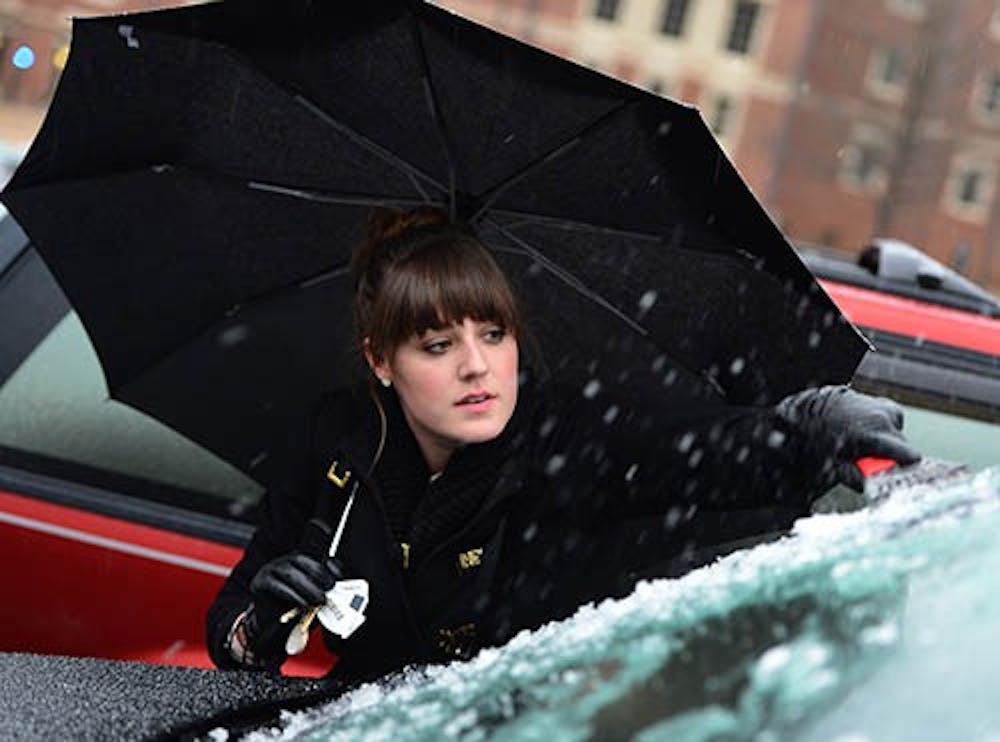 Davidson College junior Elizabeth Anderson cleans ice from the windshield of her vehicle as sleet continues to fall in Davidson, N.C. Friday, Jan. 25, 2013. The Nation has seen a number of storms in the past couple weeks. MCT PHOTO