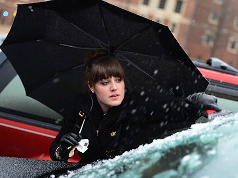Davidson College junior Elizabeth Anderson cleans ice from the windshield of her vehicle as sleet continues to fall in Davidson, N.C. Friday, Jan. 25, 2013. The Nation has seen a number of storms in the past couple weeks. MCT PHOTO
