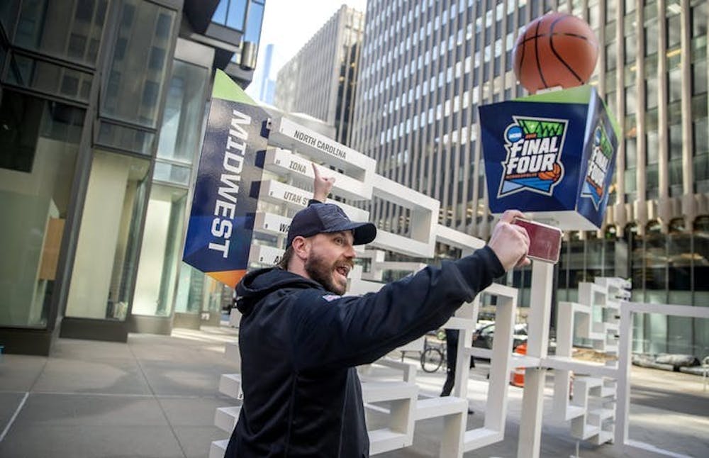 Brad Hardin took a selfie as he found his favorite team, North Carolina, on a 3-D sculpture of the Final Four bracket on the Nicollet Mall just outside the IDS Tower. (Star Tribune/TNS) 