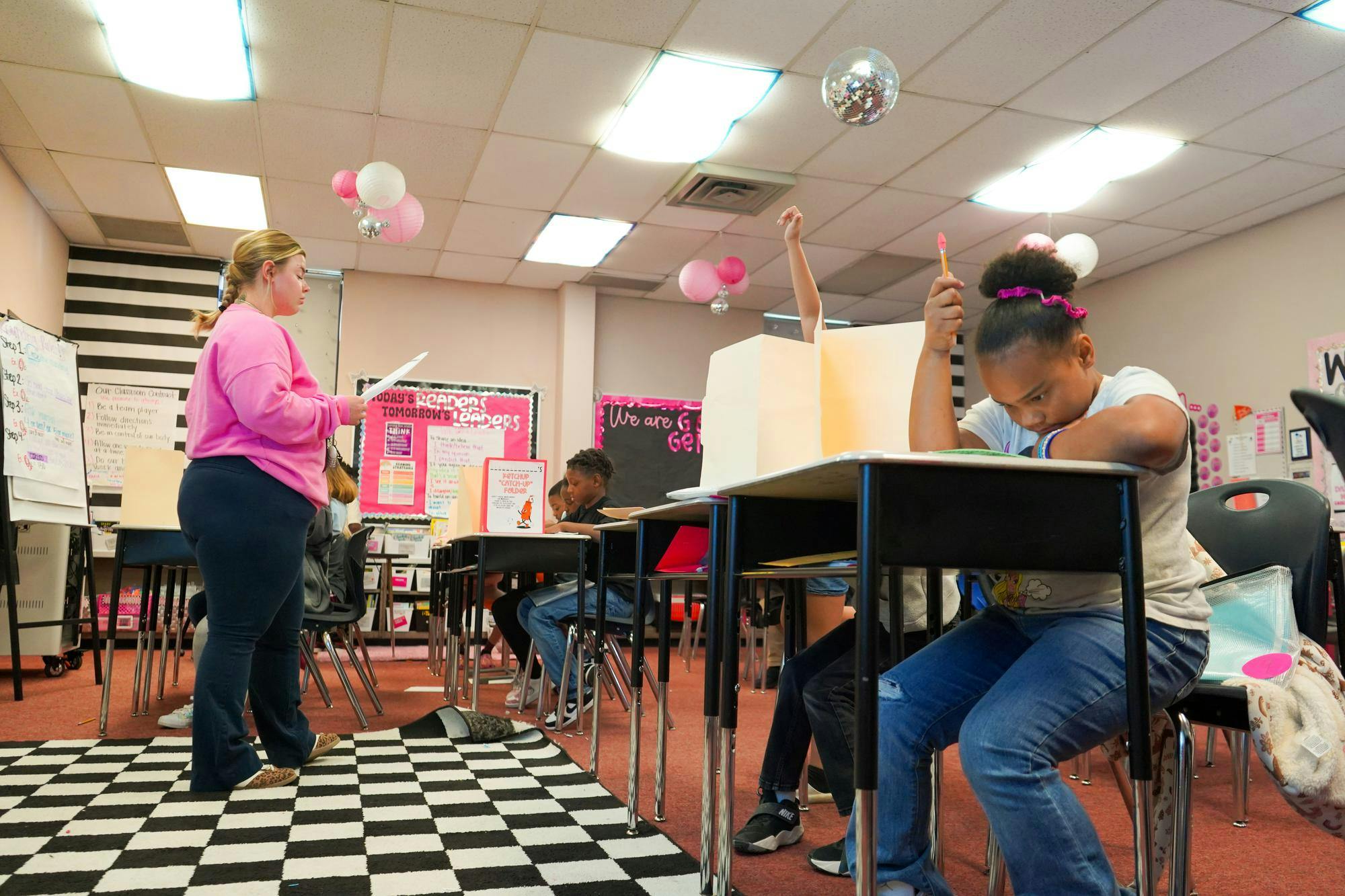 Third-grade elementary students raise their hands during a spelling test Sept. 2 at Grissom Elementary. Isabella Kemper, DN