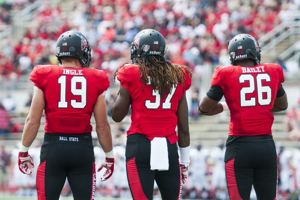 Linebackers Ben Ingle, Aaron Tayler and Avery Bailey stand at the sideline between a play during the game against Colgate on Aug. 30 at Scheumann Stadium. DN PHOTO JONATHAN MIKSANEK