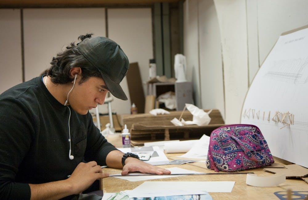 <p>Sophomore architecture major Favian Ceruantes works on a class project in s studio on the 5th floor of the CAP building. Each CAP student has their own work space. Kaiti Sullivan, DN</p>