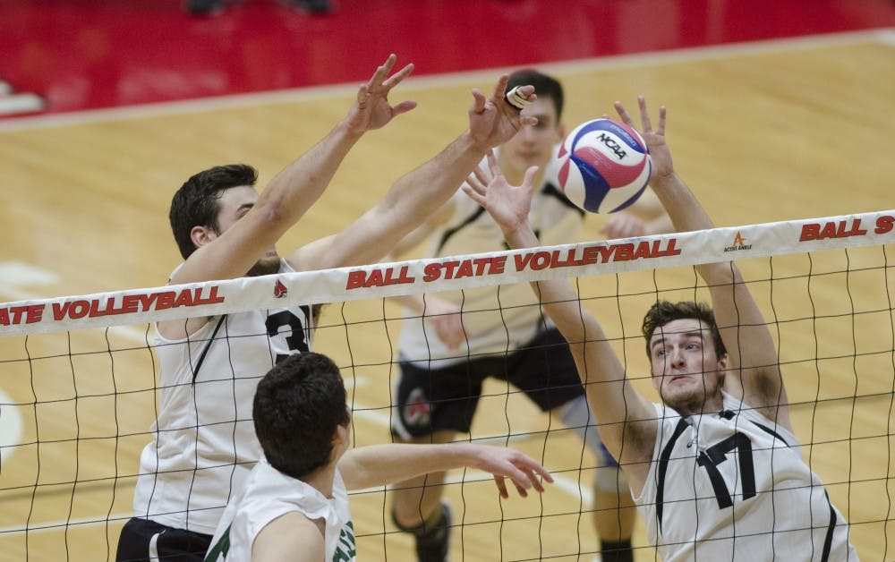 Setter Connor Gross and middle attacker Alex Pia attempt to block a hit against George Mason University on Jan. 26. Ball State won the match 3-1, improving their record to 7-1. Emma Rogers // DN