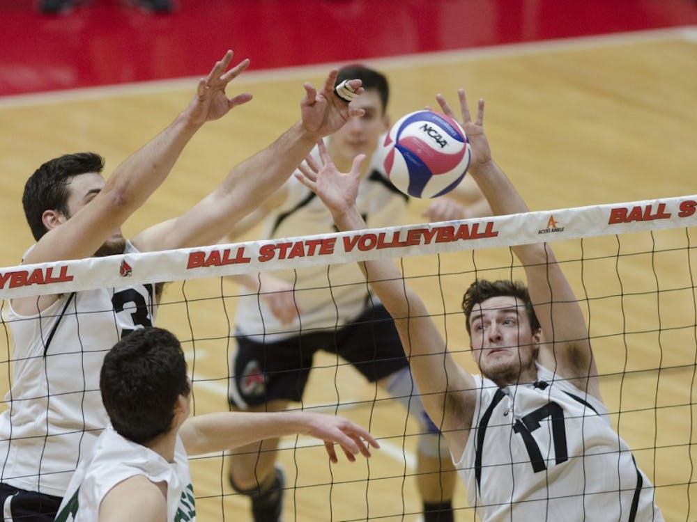 Setter Connor Gross and middle attacker Alex Pia attempt to block a hit against George Mason University on Jan. 26. Ball State won the match 3-1, improving their record to 7-1. Emma Rogers // DN