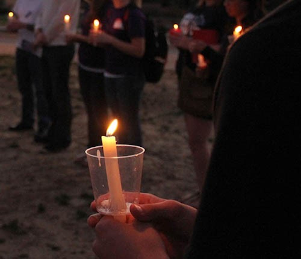 Students hold a candle light vigil to remember suicide victims and to show support for people affected by suicide. Students gather around on the University Green Sept. 10 in the evening for suicide prevention week. A Suicide Prevention advocate, Heidi Bryan, will speak at 7:30 p.m. at Pruis Hall. DN FILE PHOTO EMMA FLYNN