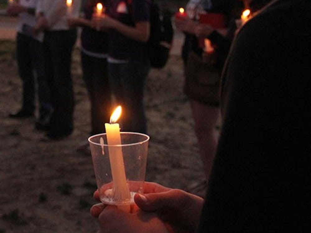 Students hold a candle light vigil to remember suicide victims and to show support for people affected by suicide. Students gather around on the University Green Sept. 10 in the evening for suicide prevention week. A Suicide Prevention advocate, Heidi Bryan, will speak at 7:30 p.m. at Pruis Hall. DN FILE PHOTO EMMA FLYNN