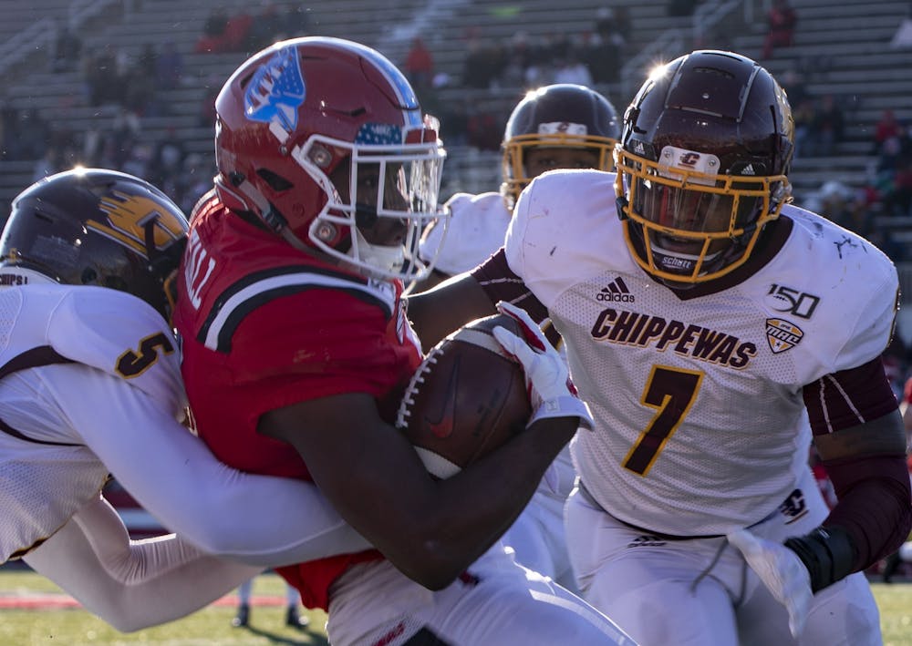 <p>Junior wide receiver Justin Hall gets tackled by Central Michigan players during the game Nov. 16, 2019, at Scheumann Stadium. Hall had two touchdowns in the game. <strong>Rebecca Slezak, DN</strong></p>