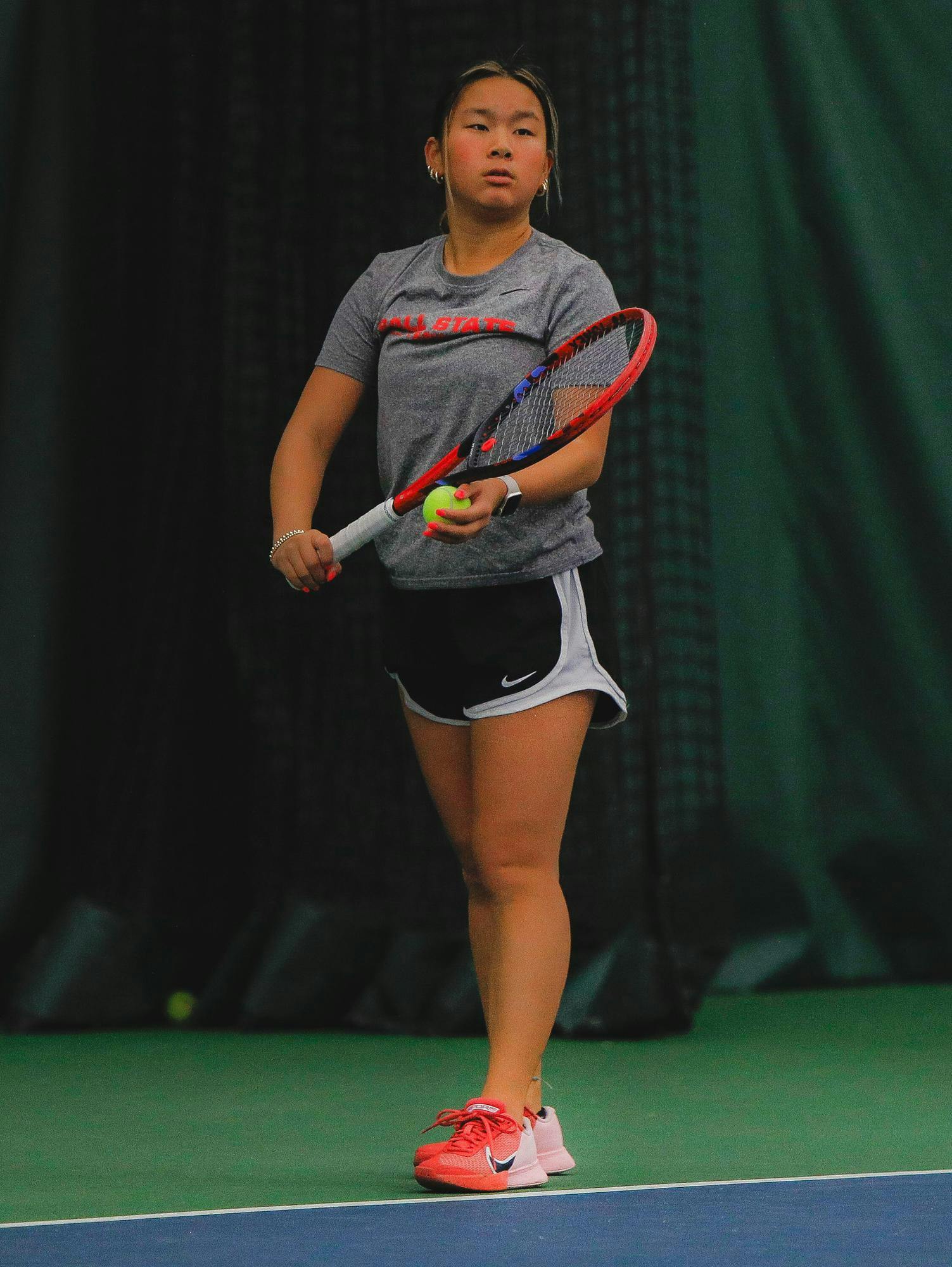 Freshman Sarah Shabaz looks to serve the ball Jan. 10 during practice at Muncie YMCA. Andrew Berger, DN 

