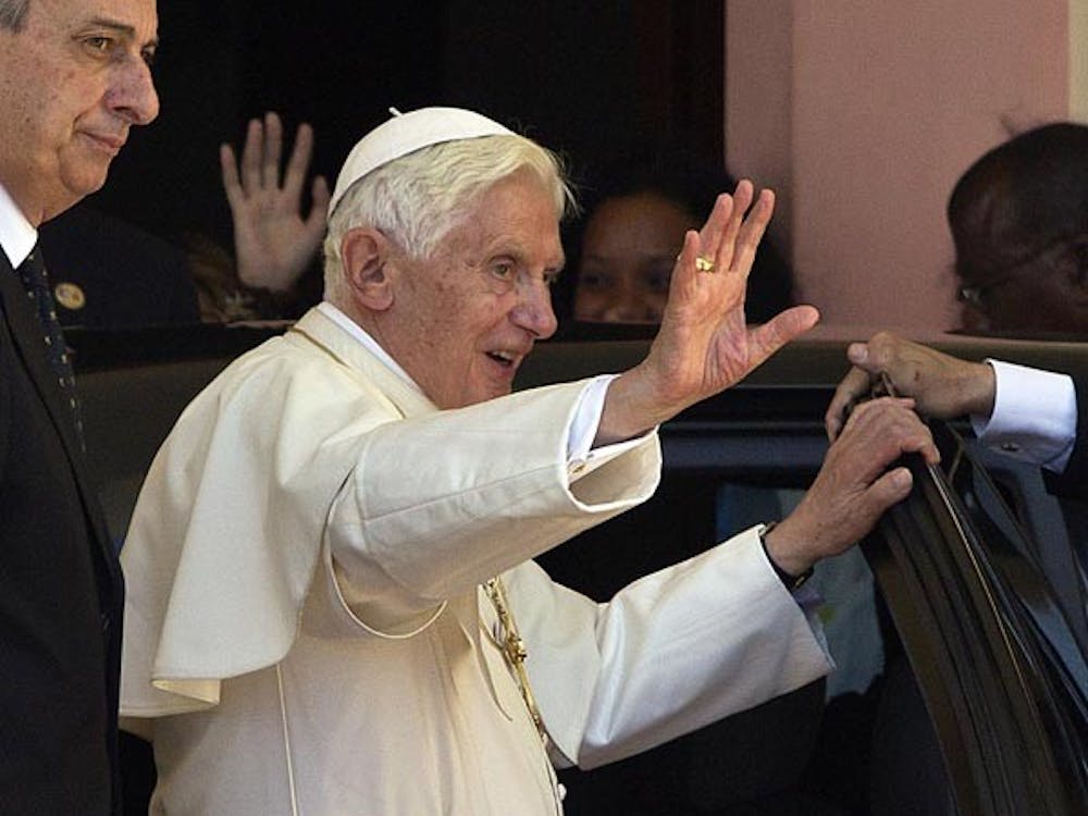 Pope Benedict XVI waves farewell to the folks of Santiago de Cuba on the steps leading up to the original statue of Our Lady of Charity, located in the Sanctuary of El Cobre on Tuesday, March 27, 2012. (Patrick Farrell/Miami Herald/MCT)