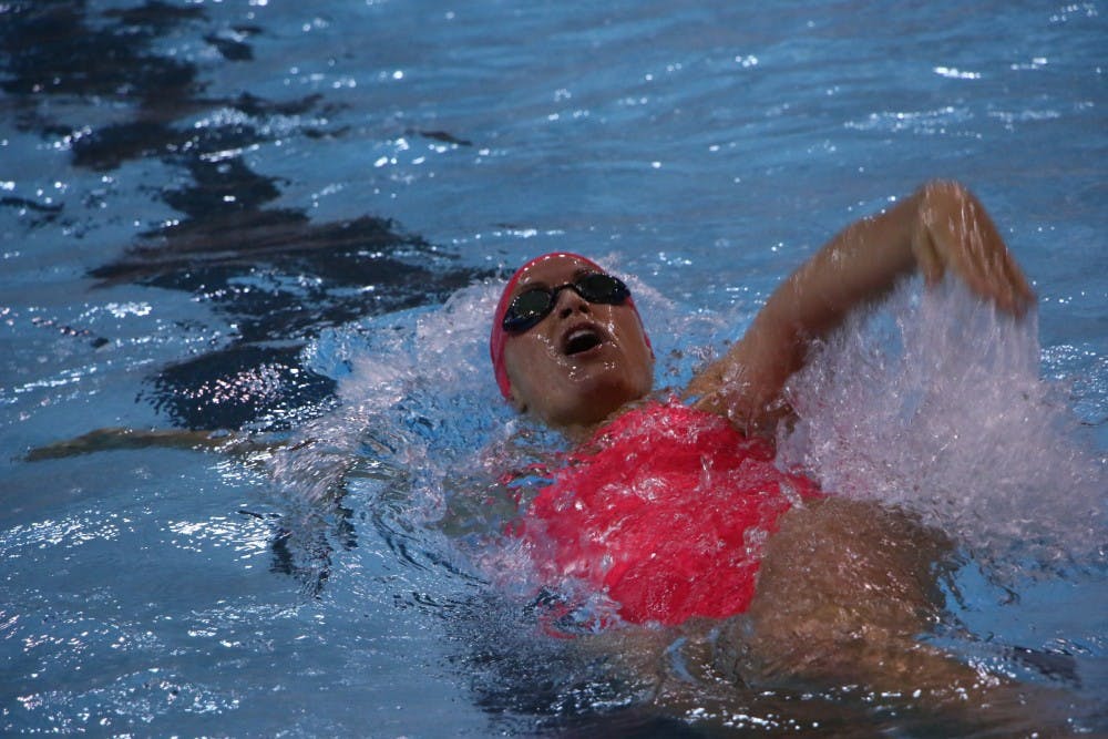 Senior Haley Richter performs the backstroke during the 100-yard backstroke event at the swim meet against Ohio University on Oct. 26 at Lewellen Aquatic Center. DN PHOTO TAYLOR IRBY