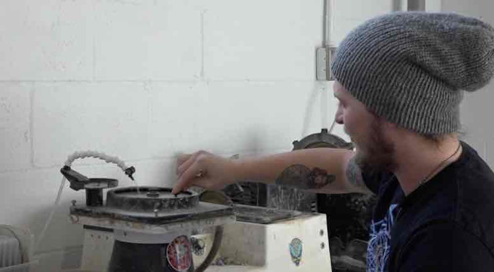 Braiden Robinson is creating pieces of stone. 