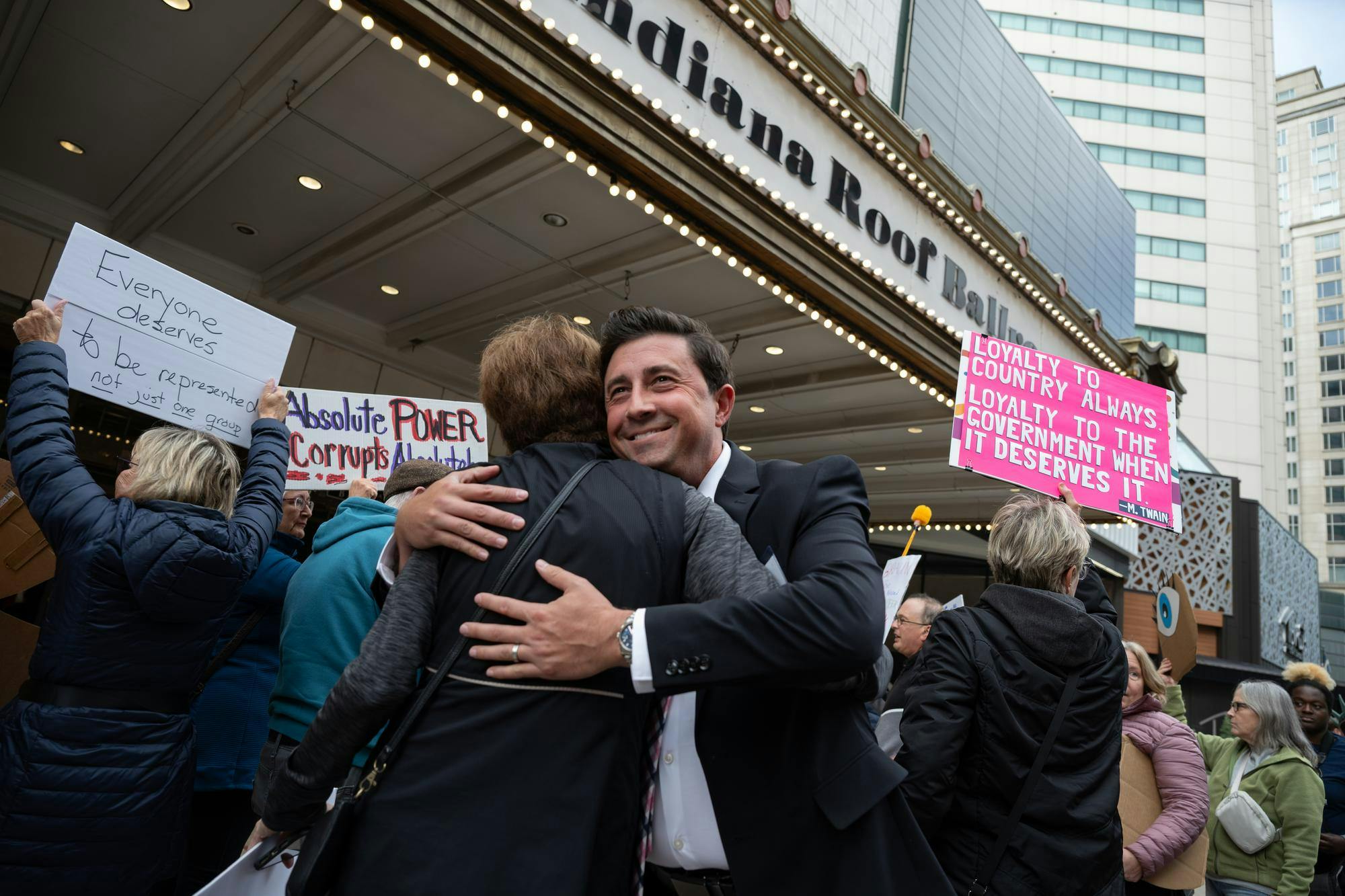 A member of the Indiana GOP greeting a familiar face among protestors against mid-cycle redistricting Oct. 27 in Indianapolis, Ind. Ryan Fleek, DN