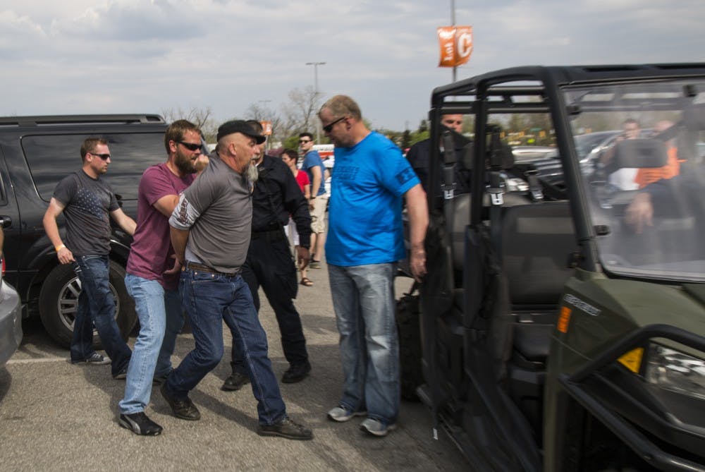 A protestor is arrested after a fight broke out in the parking lot outside a Donald Trump presidential rally at Indianapolis's fair grounds. DN PHOTO TRENT SCROGGINS