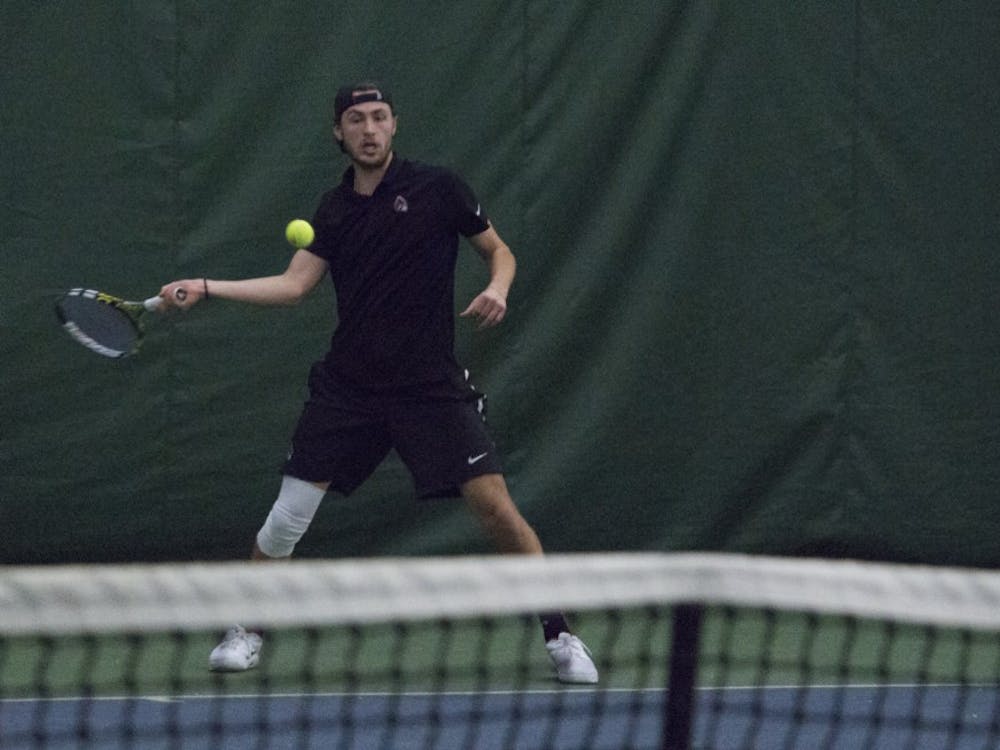 Junior Ball State men’s tennis player Conner Andersen goes to return the ball during a singles set against Eastern Illinois University on Jan. 20 at the Northwest YMCA of Muncie. During his sophomore season, Andersen had the most registered singles wins. Briana Hale, DN
