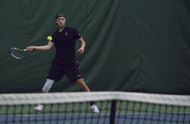 Junior Ball State men’s tennis player Conner Andersen goes to return the ball during a singles set against Eastern Illinois University on Jan. 20 at the Northwest YMCA of Muncie. During his sophomore season, Andersen had the most registered singles wins. Briana Hale, DN