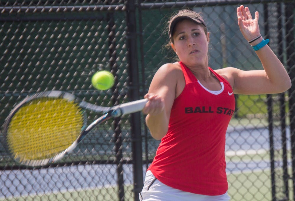 Senior Carmen Blanco hits the ball to the other side of the court during the match against Buffalo on April 2 at the Cardinal Creek Tennis Center. Blanco won her match 2-0. Teri Lightning Jr., DN