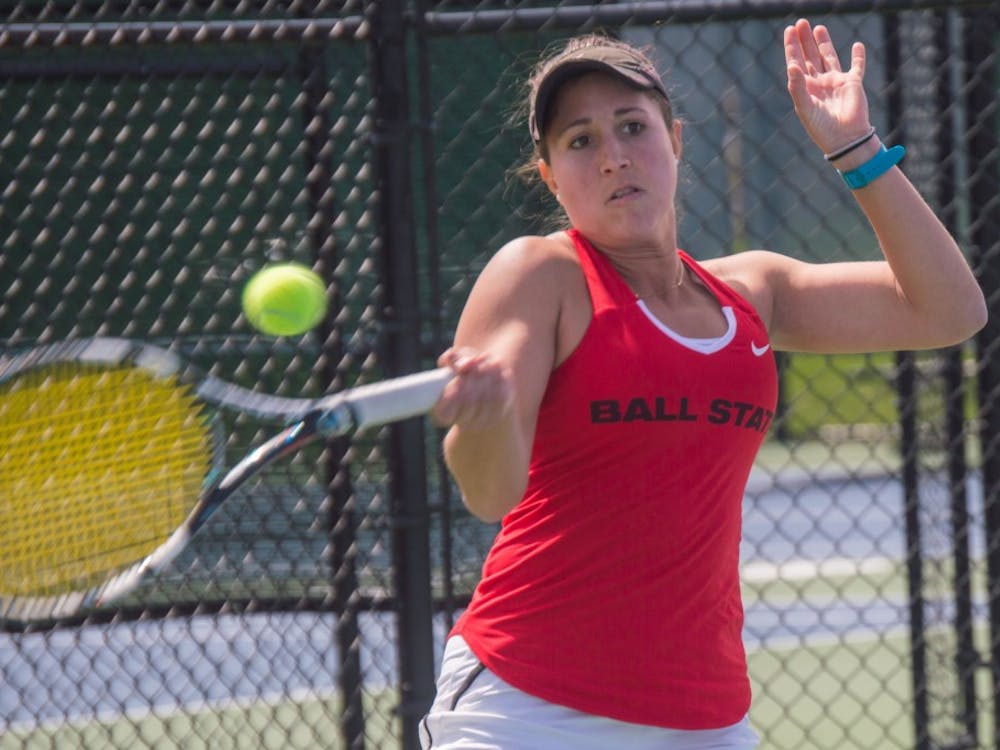 Senior Carmen Blanco hits the ball to the other side of the court during the match against Buffalo on April 2 at the Cardinal Creek Tennis Center. Blanco won her match 2-0. Terence K. Lightning Jr., DN