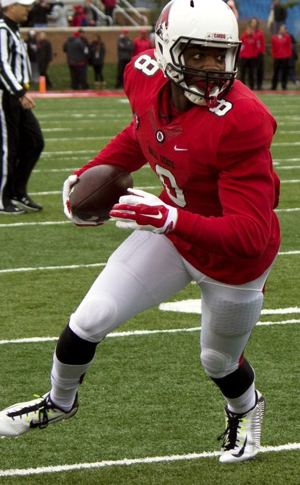 Jordan Williams, a senior wide receiver for the Ball State Cardinals, gains yards during a game against the University of Toledo on Oct. 3 at Sheumann Stadium. (Grace Ramey)