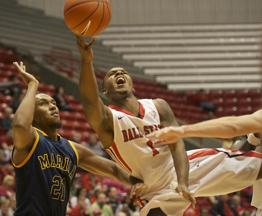 Ball State freshman Zavier Turner splits Marian defenders at Worthern Arena Nov. 4. DN PHOTO MARCEY BURTON